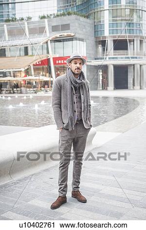 Stock Image - Portrait of businessman with hands in pockets. Fotosearch