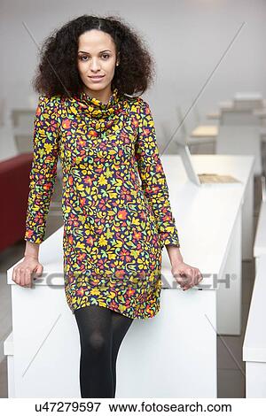 Portrait of businesswoman leaning against office desk View Large Photo Image Stock Photo - Portrait of businesswoman leaning against office desk. Fotosearch