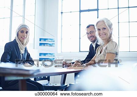 Portrait of businesswomen and man at conference table View Large Photo Image Picture - Portrait of businesswomen and man at conference table. Fotosearch