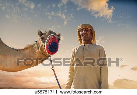 "Portrait of camel and bedouin in desert, Dubai, United Arab Emirates" View Large Photo Image Stock Image - "Portrait of camel and bedouin in desert, Dubai, United Arab Emirates". Fotosearch