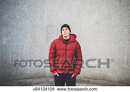 Portrait of confident young man wearing red anorak View Large Photo Image Picture - Portrait of confident young man wearing red anorak. Fotosearch