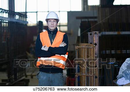 Stock Image - Portrait of factory worker in concrete reinforcement factory. Fotosearch