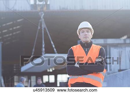 Stock Photo - Portrait of factory worker outside concrete reinforcement factory. Fotosearch