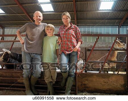 Portrait of farming family in barn with goats View Large Photo Image Stock Photo - Portrait of farming family in barn with goats. Fotosearch