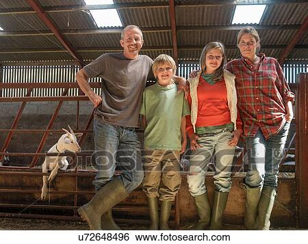 Portrait of farming family in barn with goats View Large Photo Image Stock Photograph - Portrait of farming family in barn with goats. Fotosearch