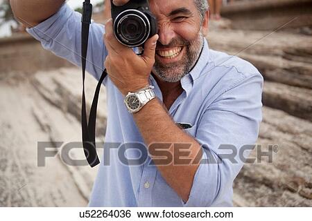 "Portrait of male photographer using digital SLR camera, Ipanema beach, Rio De Janeiro, Brazil" View Large Photo Image Stock Photograph - "Portrait of male photographer using digital SLR camera, Ipanema beach, Rio De Janeiro, Brazil". Fotosearch