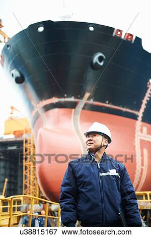 "Portrait of male worker at shipyard, GoSeong-gun, South Korea" View Large Photo Image Stock Photo - "Portrait of male worker at shipyard, GoSeong-gun, South Korea". Fotosearch