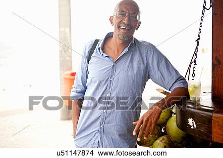 "Portrait of mature man leaning against bar on Ipanema beach, Rio De Janeiro, Brazil" View Large Photo Image Picture - "Portrait of mature man leaning against bar on Ipanema beach, Rio De Janeiro, Brazil". Fotosearch