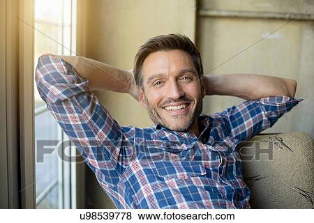Stock Photo - Portrait of mature man leaning back in cafe. Fotosearch