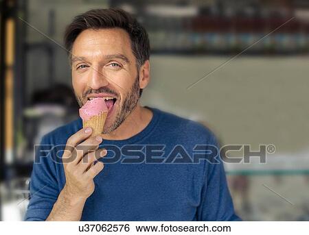 Portrait of mature man licking ice cream cone View Large Photo Image Stock Photograph - Portrait of mature man licking ice cream cone. Fotosearch