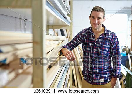 Portrait of mid adult man leaning against shelves in picture framers workshop View Large Photo Image Stock Image - Portrait of mid adult man leaning against shelves in picture framers workshop. Fotosearch