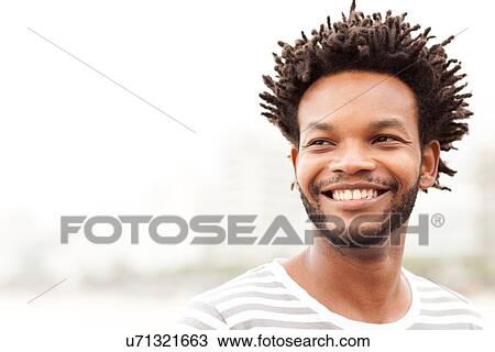 Stock Image - "Portrait of mid adult man on Ipanema Beach, Rio De Janeiro, Brazil". Fotosearch