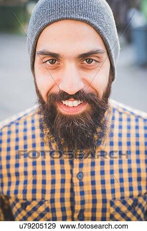 "Portrait of mid adult man wearing beanie hat, outdoors" View Large Photo Image Stock Photo - "Portrait of mid adult man wearing beanie hat, outdoors". Fotosearch