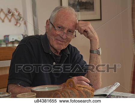"Portrait of senior man, sitting at breakfast table with newspaper" View Large Photo Image Stock Photography - "Portrait of senior man, sitting at breakfast table with newspaper". Fotosearch