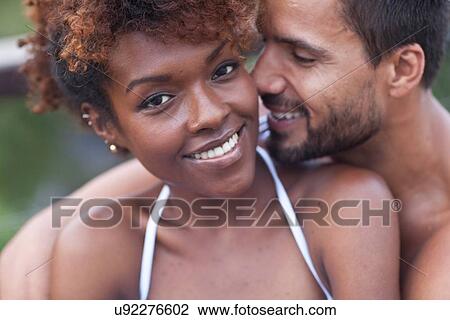 Portrait of smiling couple hugging View Large Photo Image Stock Image - Portrait of smiling couple hugging. Fotosearch
