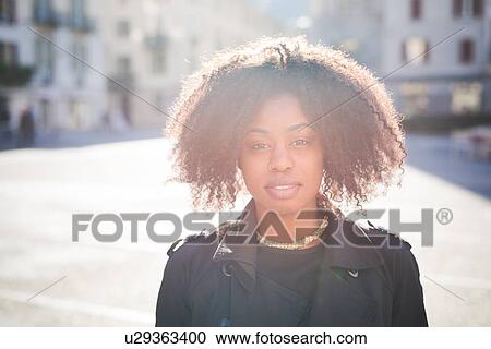 Portrait of stylish young woman in town square View Large Photo Image Stock Image - Portrait of stylish young woman in town square. Fotosearch