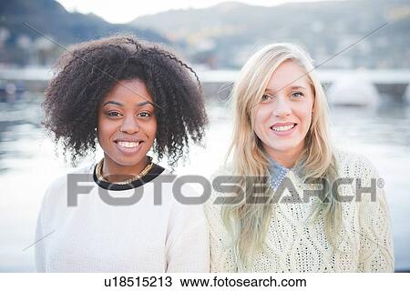 Stock Image - "Portrait of two young female friends, Lake Como, Italy". Fotosearch