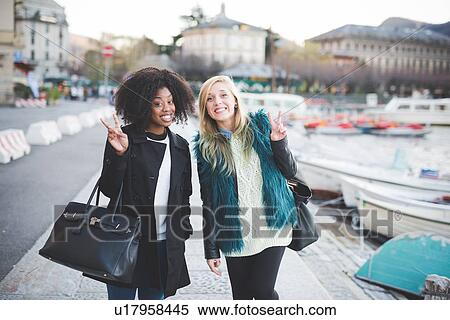 Stock Photography - "Portrait of two young female friends at Lake Como, Como, Italy". Fotosearch
