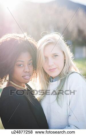 Portrait of two young women in park View Large Photo Image Stock Photo - Portrait of two young women in park. Fotosearch