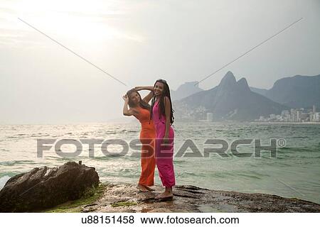 "Portrait of two young women standing on rock, Ipanema beach, Rio De Janeiro, Brazil" View Large Photo Image Stock Photo - "Portrait of two young women standing on rock, Ipanema beach, Rio De Janeiro, Brazil". Fotosearch
