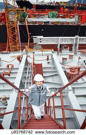 "Portrait of worker on steps at shipping port, elevated view, GoSeong-gun, South Korea" View Large Photo Image Stock Image - "Portrait of worker on steps at shipping port, elevated view, GoSeong-gun, South Korea". Fotosearch