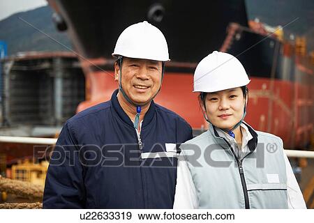 Stock Photo - "Portrait of workers at shipyard, GoSeong-gun, South Korea". Fotosearch