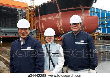 Stock Photo - "Portrait of workers at shipyard, GoSeong-gun, South Korea". Fotosearch