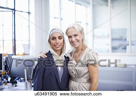 Portrait of young and mature businesswomen in office View Large Photo Image Stock Photography - Portrait of young and mature businesswomen in office. Fotosearch