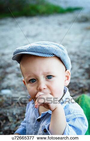 "Portrait of young boy wearing flat cap, in rural setting" View Large Photo Image Stock Photo - "Portrait of young boy wearing flat cap, in rural setting". Fotosearch