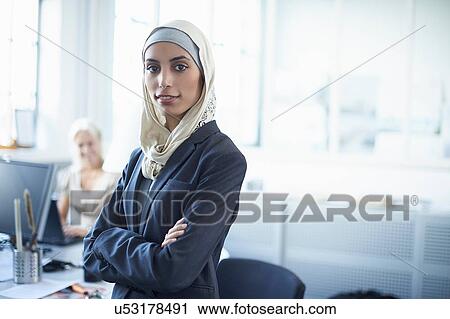 Portrait of young businesswoman wearing hijab in office View Large Photo Image Stock Image - Portrait of young businesswoman wearing hijab in office. Fotosearch