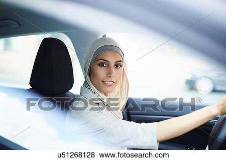 Portrait of young businesswoman wearing hijab driving car View Large Photo Image Stock Photo - Portrait of young businesswoman wearing hijab driving car. Fotosearch