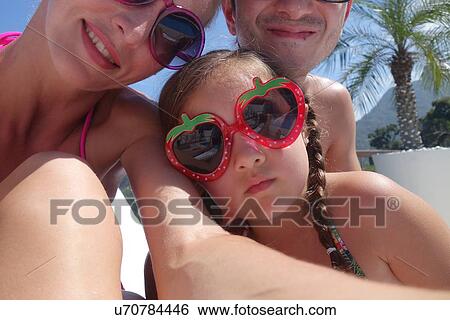 Portrait of young family wearing sunglasses View Large Photo Image Stock Photograph - Portrait of young family wearing sunglasses. Fotosearch