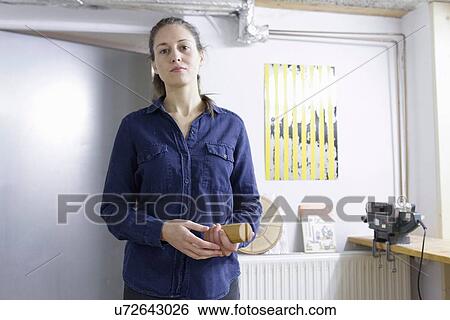 Portrait of young female carpenter in workshop View Large Photo Image Stock Photograph - Portrait of young female carpenter in workshop. Fotosearch