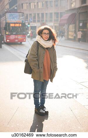 Portrait of young female commuter on street View Large Photo Image Stock Photo - Portrait of young female commuter on street. Fotosearch