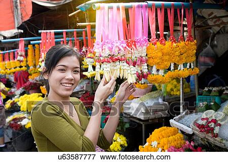 Stock Photo - "Portrait of young female market stall holder, Bangkok, Thailand". Fotosearch