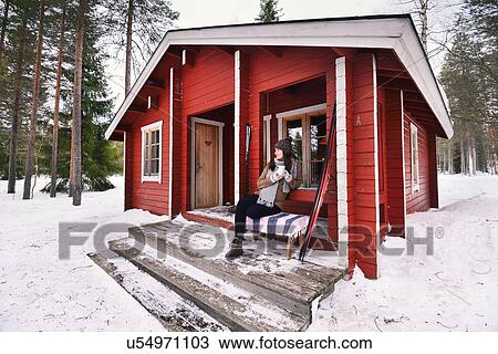 "Portrait of young female skier drinking coffee on cabin porch, Posio, Lapland, Finland" View Large Photo Image Stock Image - "Portrait of young female skier drinking coffee on cabin porch, Posio, Lapland, Finland". Fotosearch