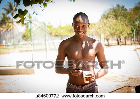 Portrait of young male basketball player with and drinking water and smartphone View Large Photo Image Stock Image - Portrait of young male basketball player with and drinking water and smartphone. Fotosearch