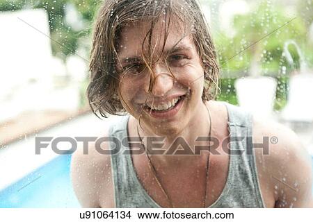 "Portrait of young man behind window of hotel swimming pool, Rio De Janeiro, Brazil" View Large Photo Image Picture - "Portrait of young man behind window of hotel swimming pool, Rio De Janeiro, Brazil". Fotosearch