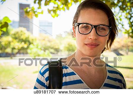 Portrait of young man wearing eyeglasses View Large Photo Image Stock Photo - Portrait of young man wearing eyeglasses. Fotosearch