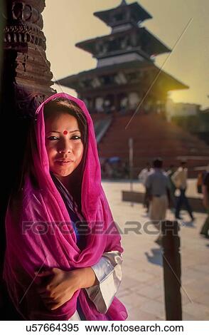 "Portrait of young Nepalese woman sitting outside temple, Kathmandu, Nepal" View Large Photo Image Stock Photography - "Portrait of young Nepalese woman sitting outside temple, Kathmandu, Nepal". Fotosearch