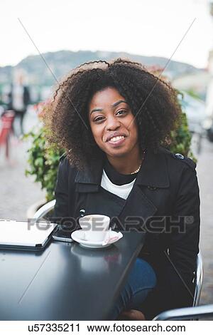 "Portrait of young woman at sidewalk cafe table, Lake Como, Como, Italy" View Large Photo Image Stock Image - "Portrait of young woman at sidewalk cafe table, Lake Como, Como, Italy". Fotosearch