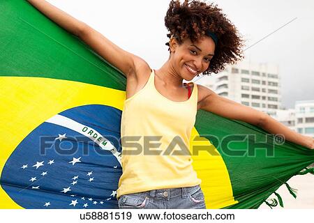 "Portrait of young woman dancing with Brazilian flag on Ipanema beach, Rio De Janeiro, Brazil" View Large Photo Image Stock Photo - "Portrait of young woman dancing with Brazilian flag on Ipanema beach, Rio De Janeiro, Brazil". Fotosearch
