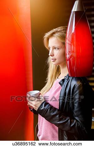 Portrait of young woman drinking coffee and gazing in cafe View Large Photo Image Stock Image - Portrait of young woman drinking coffee and gazing in cafe. Fotosearch