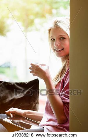 Portrait of young woman drinking coffee in cafe View Large Photo Image Stock Photo - Portrait of young woman drinking coffee in cafe. Fotosearch