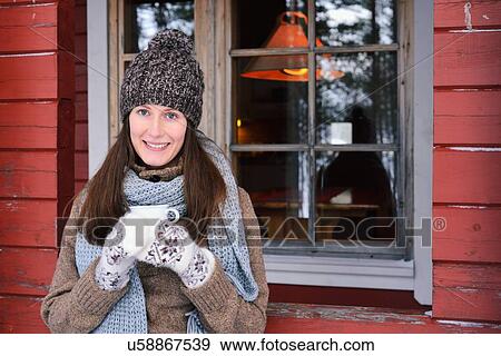"Portrait of young woman drinking coffee in front of cabin, Posio, Lapland, Finland" View Large Photo Image Stock Photo - "Portrait of young woman drinking coffee in front of cabin, Posio, Lapland, Finland". Fotosearch