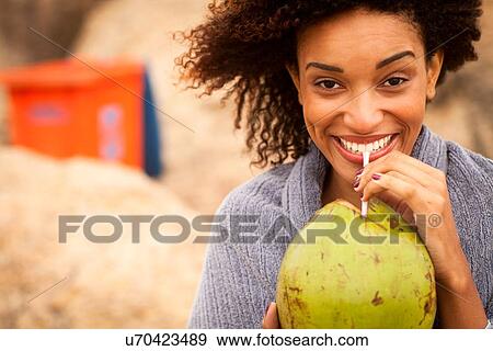 "Portrait of young woman drinking coconut milk on Ipanema Beach, Rio De Janeiro, Brazil" View Large Photo Image Stock Photo - "Portrait of young woman drinking coconut milk on Ipanema Beach, Rio De Janeiro, Brazil". Fotosearch