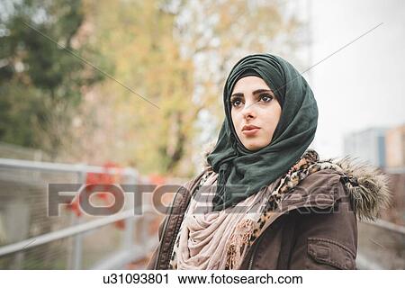 Portrait of young woman gazing from park path View Large Photo Image Stock Image - Portrait of young woman gazing from park path. Fotosearch