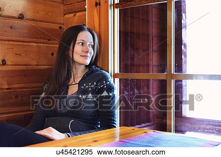 Portrait of young woman gazing out of cabin window View Large Photo Image Stock Photography - Portrait of young woman gazing out of cabin window. Fotosearch