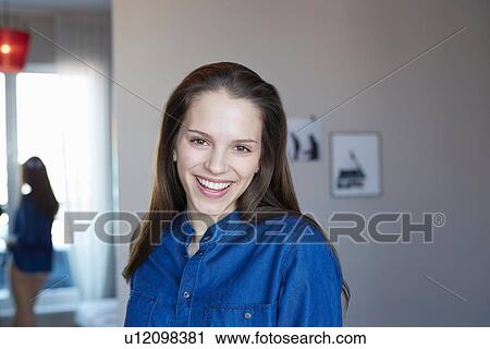 Portrait of young woman in room View Large Photo Image Stock Image - Portrait of young woman in room. Fotosearch