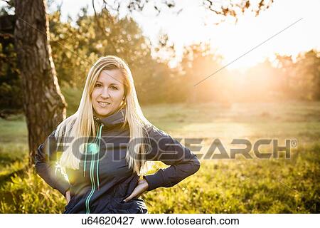 Portrait of young woman in sunlit park View Large Photo Image Stock Photo - Portrait of young woman in sunlit park. Fotosearch